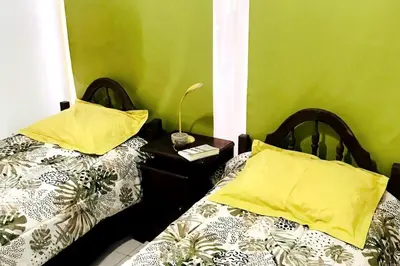two beds sitting next to each other in a room at Cálido Loft con pileta cerca del centro. in Villa Carlos Paz
