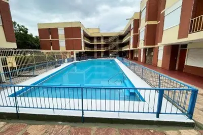 a swimming pool in front of a building at Cálido Loft con pileta cerca del centro. in Villa Carlos Paz