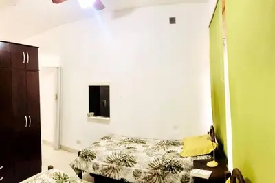 a bedroom with a bed and a dresser in it at Cálido Loft con pileta cerca del centro. in Villa Carlos Paz