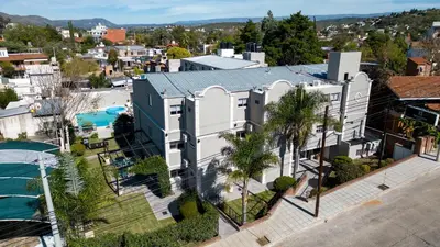 an aerial view of a house with a pool at Nuevo Centro Hotel Villa Carlos Paz in Villa Carlos Paz