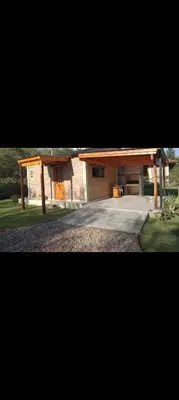 a house with a pavilion in a yard at La Quina. in Villa Rumipal