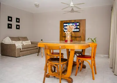 a living room with a wooden table and chairs at Depto 5 in Villa Carlos Paz