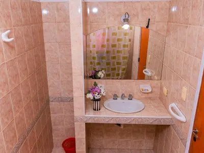 a bathroom with a sink and a mirror at Depto 5 in Villa Carlos Paz