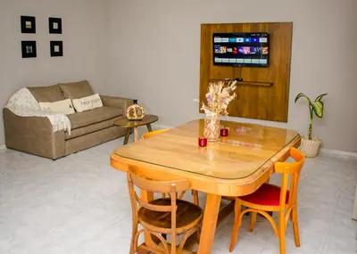 a living room with a wooden table and chairs at Depto 5 in Villa Carlos Paz