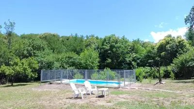 two white chairs sitting in front of a pool at Las Toribias I in Merlo