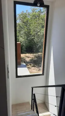 a stairwell with a large window in a house at Las Toribias I in Merlo