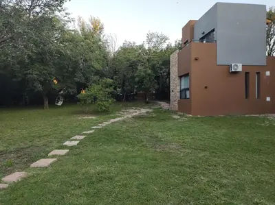 a house with a stone path next to a yard at Las Toribias I in Merlo