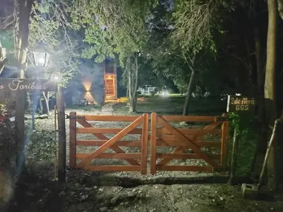 a wooden gate in front of a house at night at Las Toribias I in Merlo