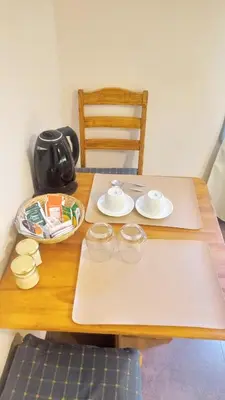 a wooden table with plates and bowls on it at Dormis:Lodesilvi in Merlo