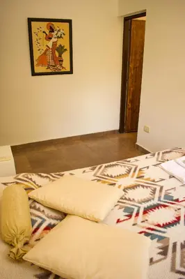 a bed with two pillows on it in a room at Dormis:Lodesilvi in Merlo