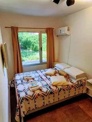 a bedroom with a bed with a window at Dormis:Lodesilvi in Merlo