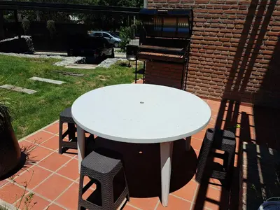a white table and chairs on a patio at Departamento Entero 2 Dormitorios B° Urca con Cochera in Cordoba