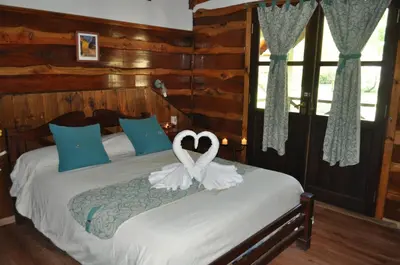 a bedroom with a bed with a heart decoration on it at Cabañas Aufenthalt in Villa General Belgrano