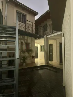 an empty courtyard of a house with a staircase at AMPLIOS Departamentos PASAJE TUCUMÁN in Alta Gracia