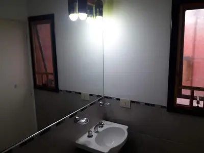 a bathroom with a sink and a mirror at Departamento de Caroya in Villa Carlos Paz