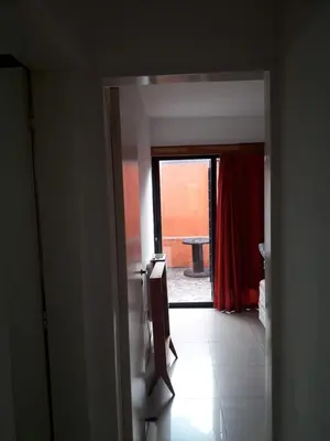 a hallway with a door open to a room with a window at Departamento de Caroya in Villa Carlos Paz
