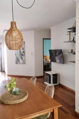a dining room with a table and a living room at Refugio en Nueva Córdoba Excelente ubicación in Cordoba