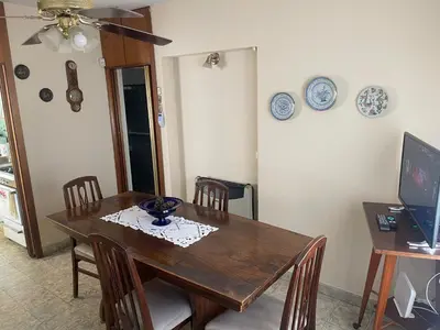 a dining room with a wooden table and chairs at Casa Rosa in Alta Gracia