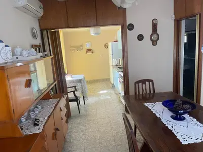 a kitchen with a table and a dining room at Casa Rosa in Alta Gracia