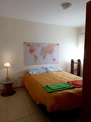 a bedroom with a bed with a map on the wall at La Lunita in Cordoba