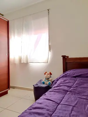a teddy bear sitting on a pillow next to a bed at La Lunita in Cordoba