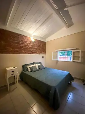 a bedroom with a blue bed and a window at Departamento Sofía in Tanti