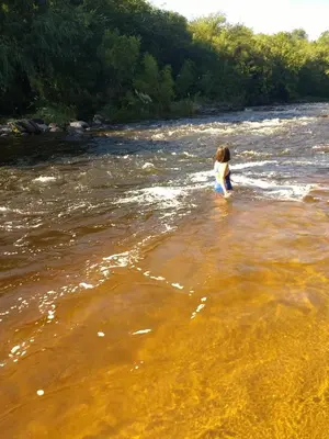 a woman standing in the water in a river at SAN ANTONIO de Arredondo la casa de Andrea in San Antonio de Arredondo