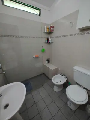 a bathroom with a white toilet and a sink at SAN ANTONIO de Arredondo la casa de Andrea in San Antonio de Arredondo