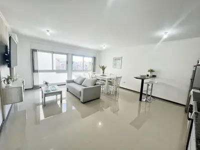a living room with a couch and a table at VENETO V DEPARTAMENTOS in Villa Carlos Paz