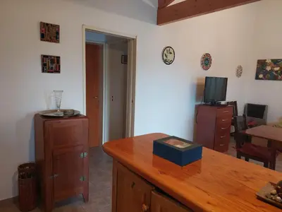 a living room with a wooden counter and a tv at La Casita - Chalet de Montaña in Villa General Belgrano