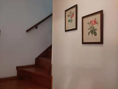 two pictures of flowers on a wall with stairs at La Casita - Chalet de Montaña in Villa General Belgrano