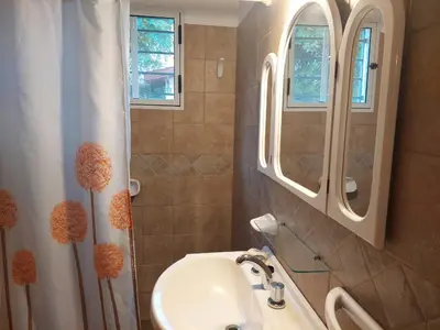 a bathroom with a sink and a mirror at La Casita - Chalet de Montaña in Villa General Belgrano