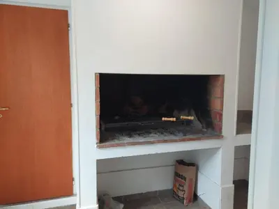 a fire place in a room with a fireplace at La Casita - Chalet de Montaña in Villa General Belgrano