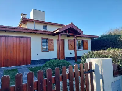 a house with a wooden fence in front of it at La Casita - Chalet de Montaña in Villa General Belgrano