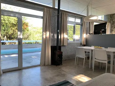 a living room with a table and chairs and a fireplace at Jauja in San Javier