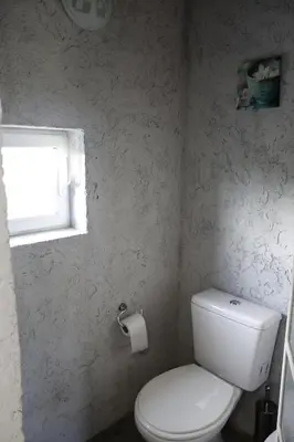 a bathroom with a white toilet and a window at Jauja in San Javier