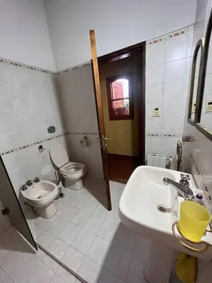 a bathroom with a sink and a toilet and a sink at Hermosa casa en el corazón de Alta Córdoba in Cordoba
