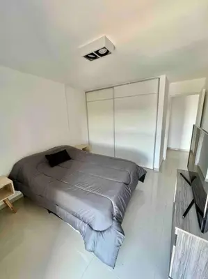 a bedroom with a bed in a white room at Departamento para dos personas in Cordoba
