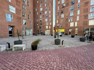 a brick courtyard with potted plants in front of a building at Departamento para dos personas in Cordoba