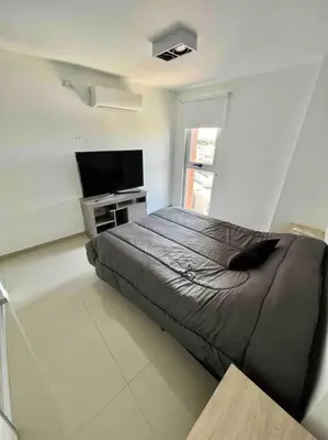 a bedroom with a bed and a flat screen tv at Departamento para dos personas in Cordoba