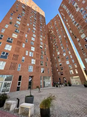 a large brick building with two tall buildings at Departamento para dos personas in Cordoba