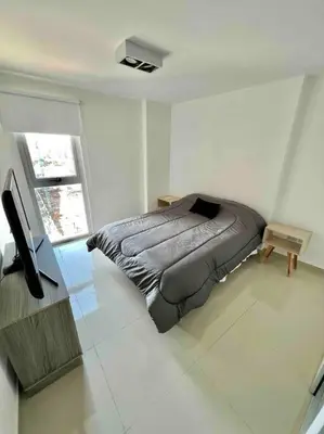 a bedroom with a bed and a television in it at Departamento para dos personas in Cordoba