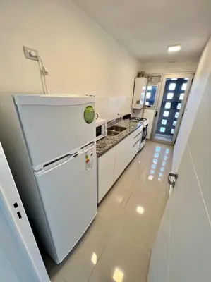 a kitchen with a white refrigerator in a room at Departamento para dos personas in Cordoba