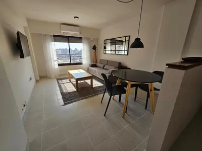 a living room with a table and a couch at Güemes apartamento in Cordoba
