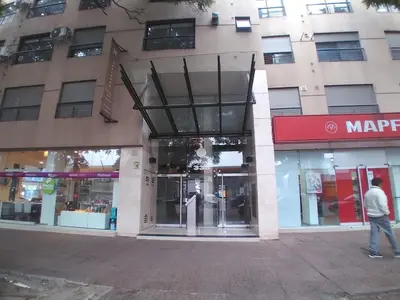 a man walking in front of a building at Güemes apartamento in Cordoba