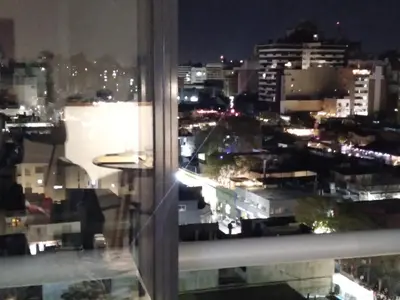 a view of a city at night from a window at Güemes apartamento in Cordoba