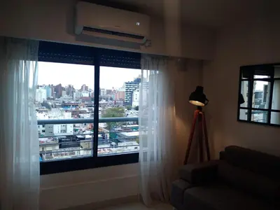 a room with a window with a view of a city at Güemes apartamento in Cordoba