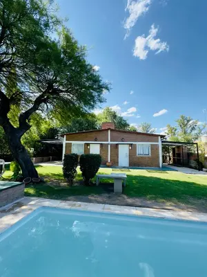 a swimming pool in front of a house at La Algarroba in Alta Gracia