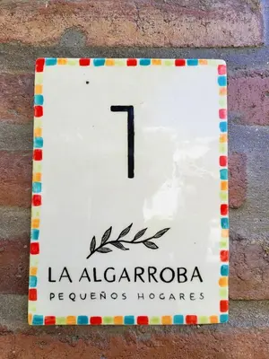 a clock on the side of a brick wall at La Algarroba in Alta Gracia