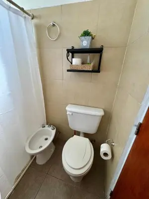 a small bathroom with a toilet and a sink at La Algarroba in Alta Gracia